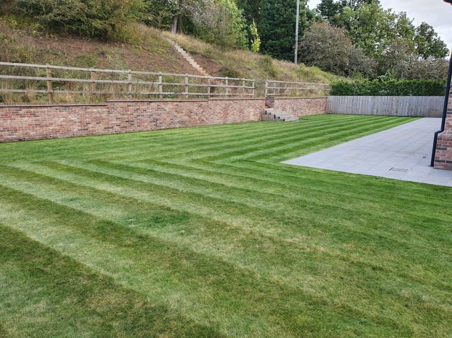 L shaped garden grass cut leaving stripes in lawn
