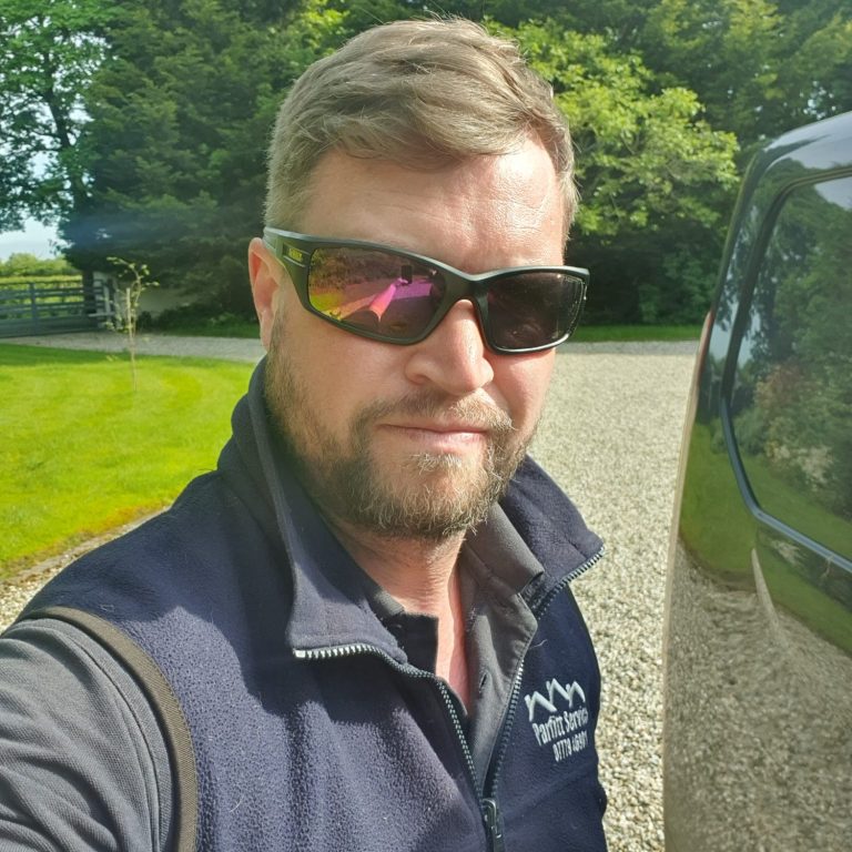 Parfitt Services business owner wearing sunglasses and workwear with logo